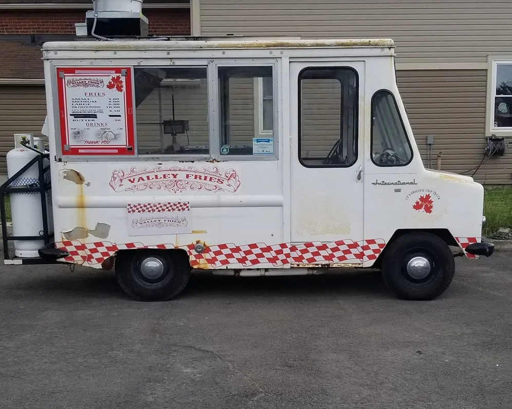The truck from the side, with its red-and-white checker trim